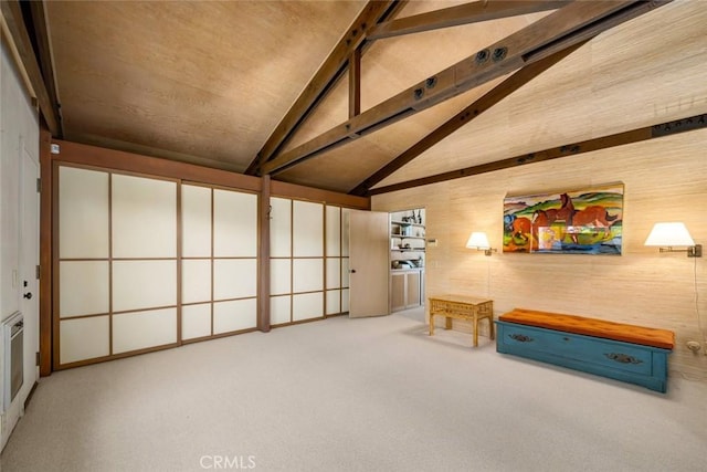 interior space with vaulted ceiling with beams