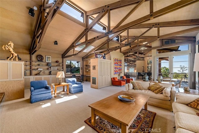 carpeted living room with french doors, high vaulted ceiling, and beam ceiling