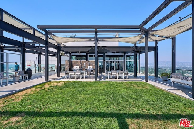 exterior space featuring a pergola and a lawn