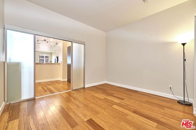 empty room with hardwood / wood-style floors