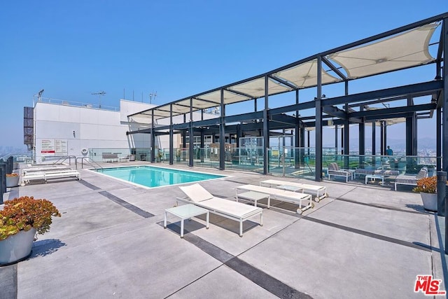 view of swimming pool with a patio area