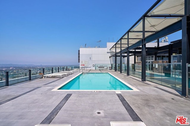 view of swimming pool featuring a patio area