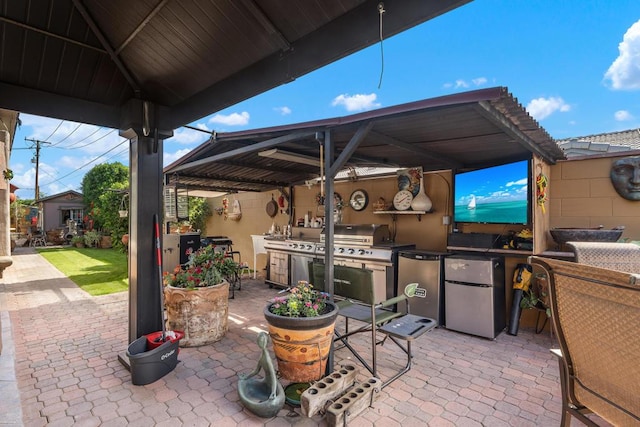 view of patio / terrace with grilling area and an outdoor kitchen