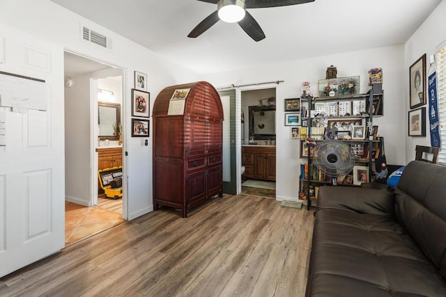 living room with ceiling fan and wood-type flooring