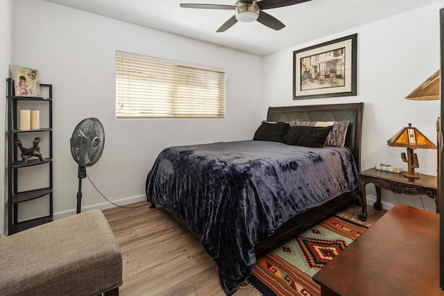 bedroom with ceiling fan and light hardwood / wood-style flooring