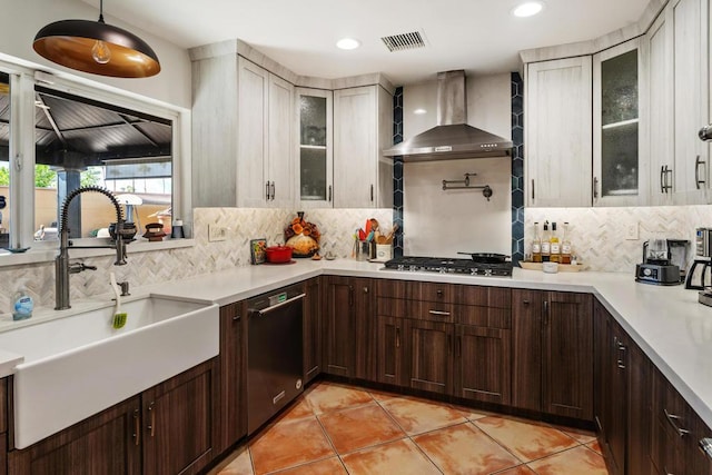 kitchen featuring tasteful backsplash, sink, wall chimney exhaust hood, and stainless steel appliances