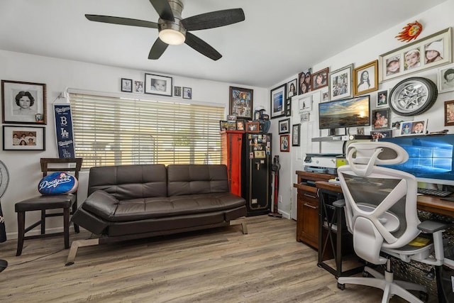 home office featuring light hardwood / wood-style floors and ceiling fan