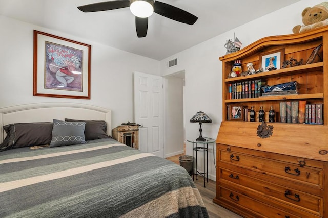 bedroom with hardwood / wood-style floors and ceiling fan