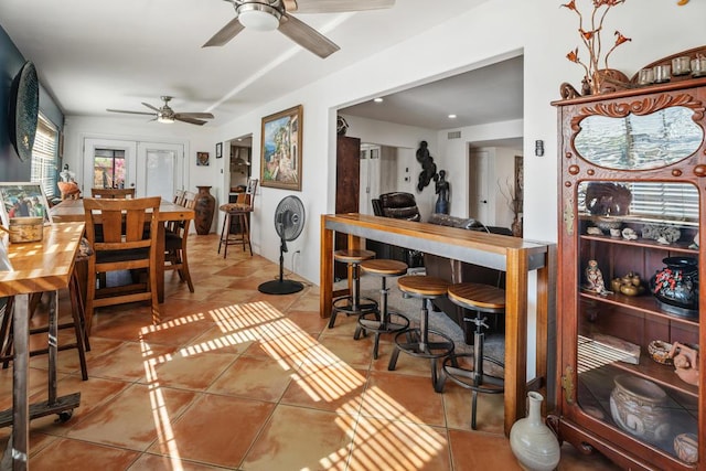 dining space with tile patterned flooring, ceiling fan, and french doors