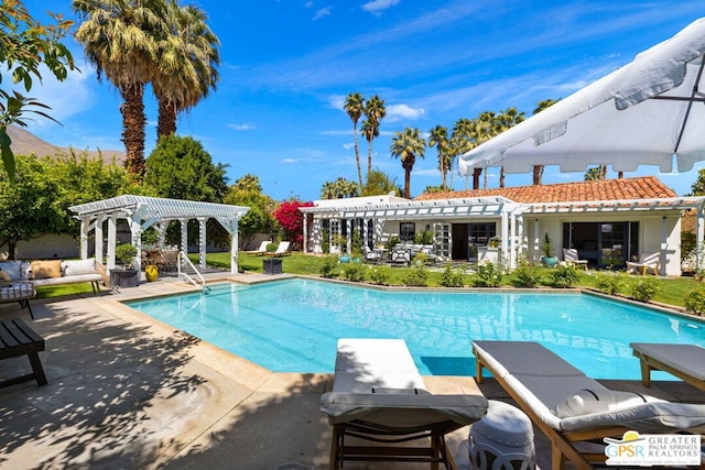 view of pool with a diving board, a pergola, and a patio