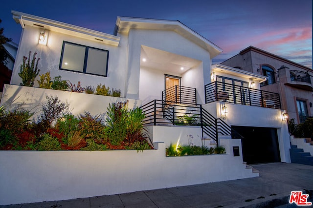 modern home with a garage and a balcony