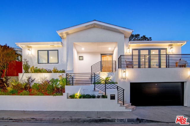 modern home featuring a garage and a balcony