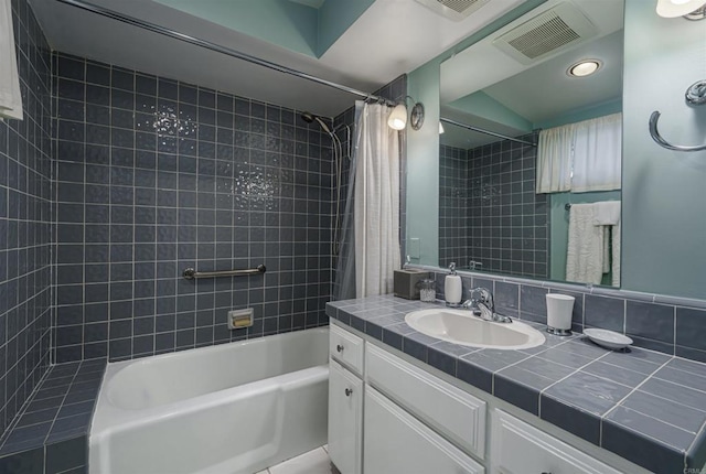 bathroom with backsplash, vanity, and shower / bath combo