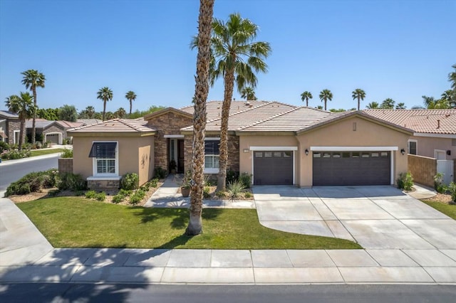 view of front of property with a front yard and a garage