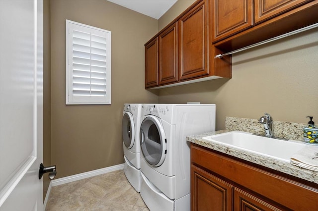 laundry area with separate washer and dryer, sink, light tile patterned flooring, and cabinets