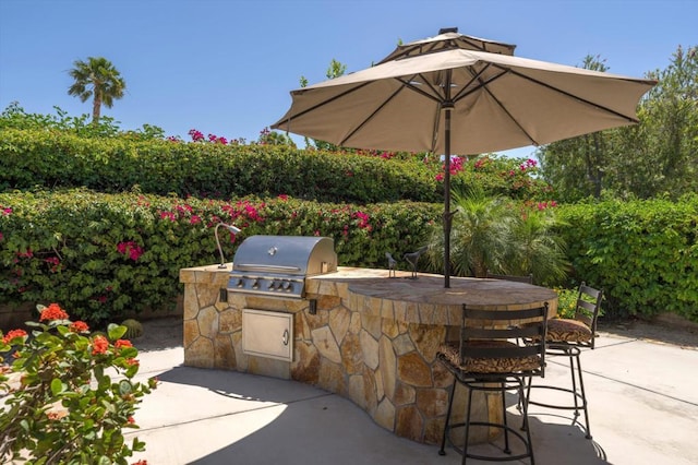 view of patio with a bar, area for grilling, and grilling area