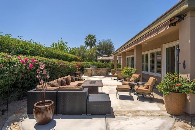 view of patio / terrace featuring an outdoor living space with a fire pit