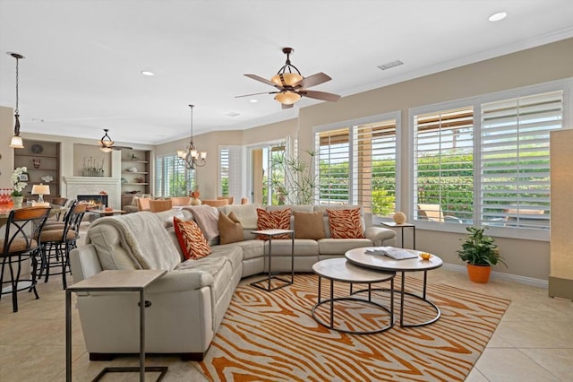 tiled living room featuring built in shelves, ceiling fan with notable chandelier, and crown molding