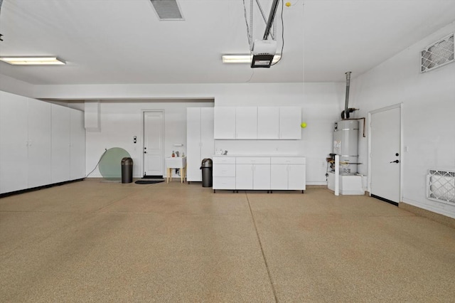 garage featuring secured water heater, a garage door opener, and sink