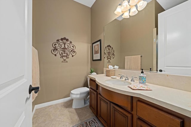 bathroom featuring tile patterned flooring, vanity, and toilet