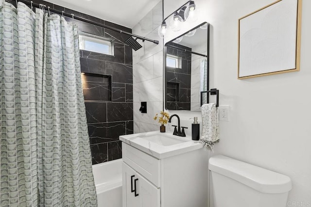 full bathroom featuring vanity, toilet, and shower / tub combo