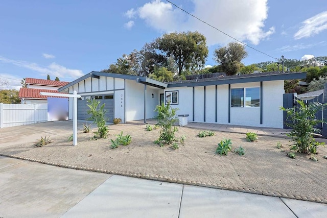 rear view of house featuring a garage