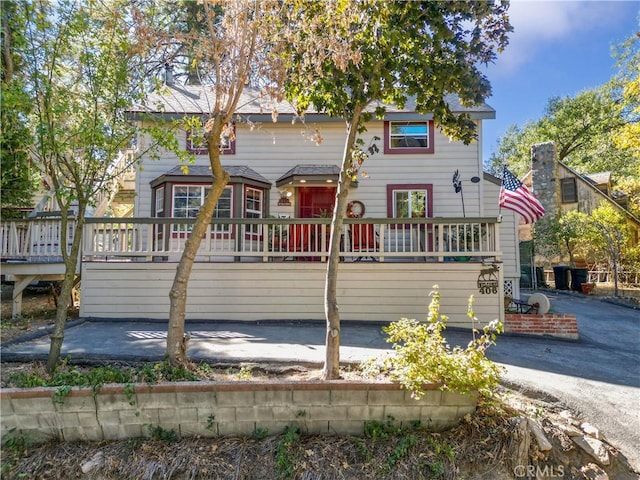 view of front of property with a patio area and a wooden deck