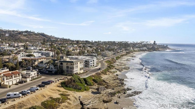 aerial view with a water view and a beach view