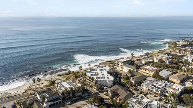 bird's eye view featuring a water view and a beach view