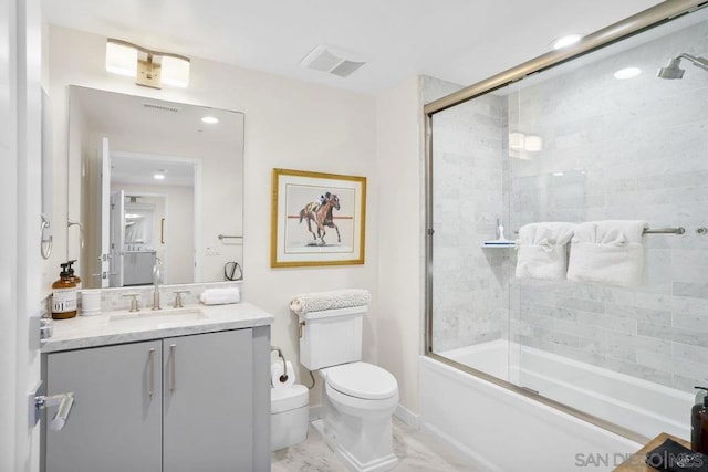 full bathroom featuring enclosed tub / shower combo, toilet, and vanity