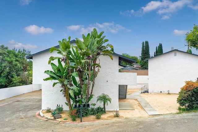 view of property exterior with a patio area