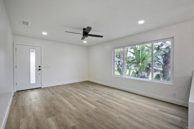 unfurnished room featuring light hardwood / wood-style floors and ceiling fan