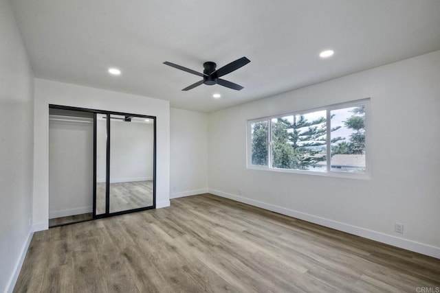 unfurnished bedroom featuring light hardwood / wood-style flooring and ceiling fan