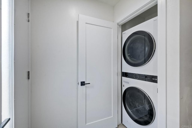 washroom featuring stacked washing maching and dryer