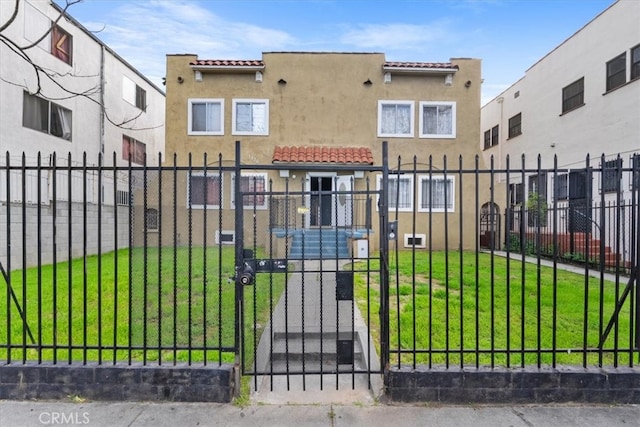 view of gate featuring a yard