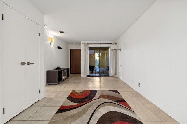 corridor featuring light tile patterned floors