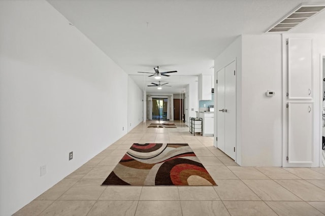 hall featuring light tile patterned floors