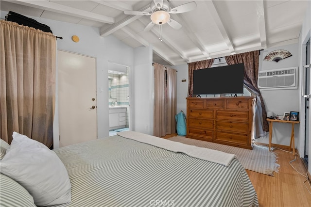 bedroom featuring connected bathroom, vaulted ceiling with beams, a wall mounted air conditioner, light hardwood / wood-style floors, and ceiling fan