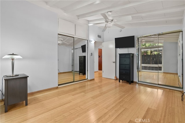 unfurnished living room featuring vaulted ceiling with beams, a baseboard heating unit, light wood-type flooring, and ceiling fan