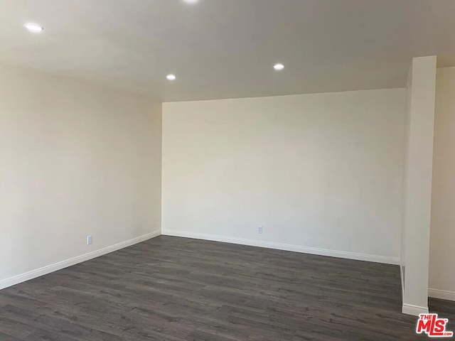 empty room with dark hardwood / wood-style floors