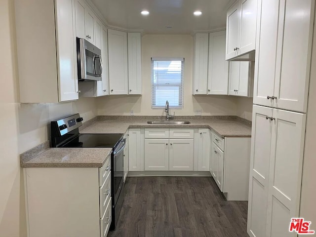 kitchen with white cabinets, stainless steel appliances, dark hardwood / wood-style floors, and sink