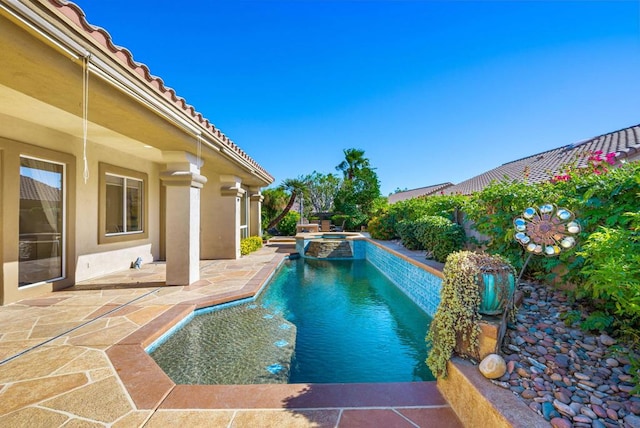 view of pool featuring an in ground hot tub and a patio