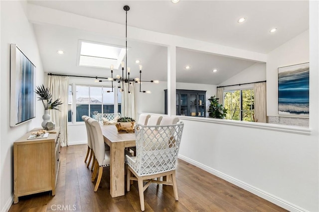 dining space with hardwood / wood-style floors, a notable chandelier, and vaulted ceiling with beams