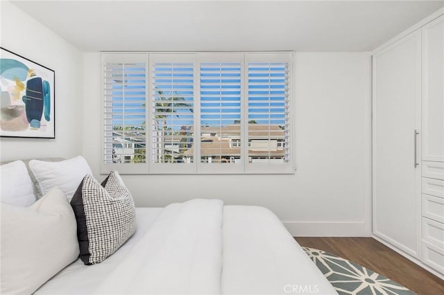 bedroom with dark hardwood / wood-style flooring