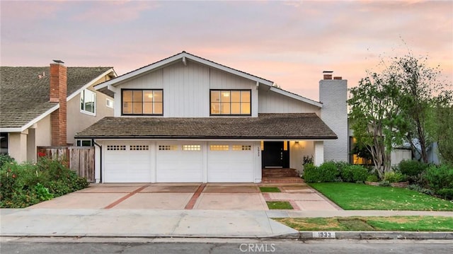 view of front property with a yard and a garage