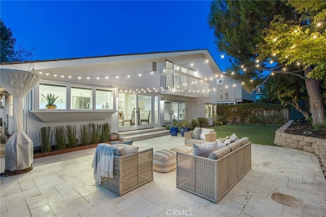 view of patio with an outdoor hangout area, french doors, and a balcony