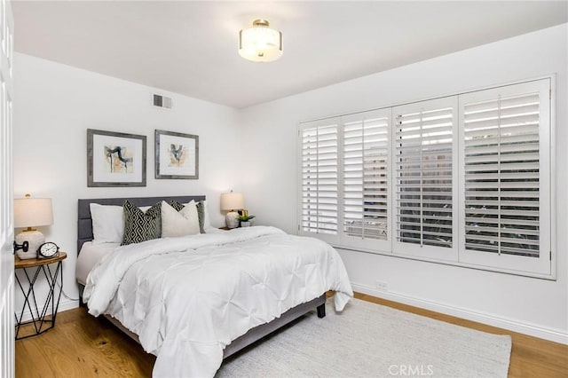 bedroom with hardwood / wood-style floors