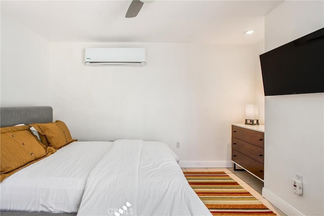 bedroom featuring a wall unit AC and ceiling fan