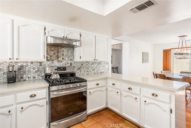 kitchen with kitchen peninsula, backsplash, stainless steel gas range, pendant lighting, and white cabinetry