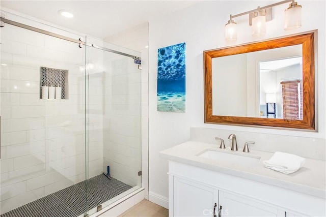 bathroom featuring vanity and a shower with shower door